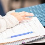 Close up of student typing on a keyboard in class
