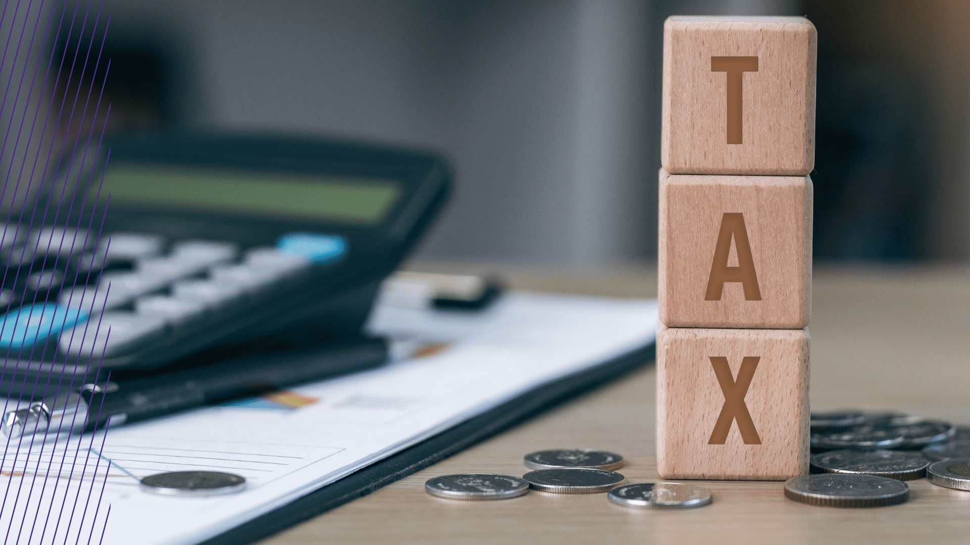 EITC Blocks spell out tax on desk next to coins and a calculator