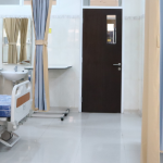 An empty hospital room with multiple beds