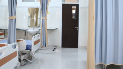 An empty hospital room with multiple beds