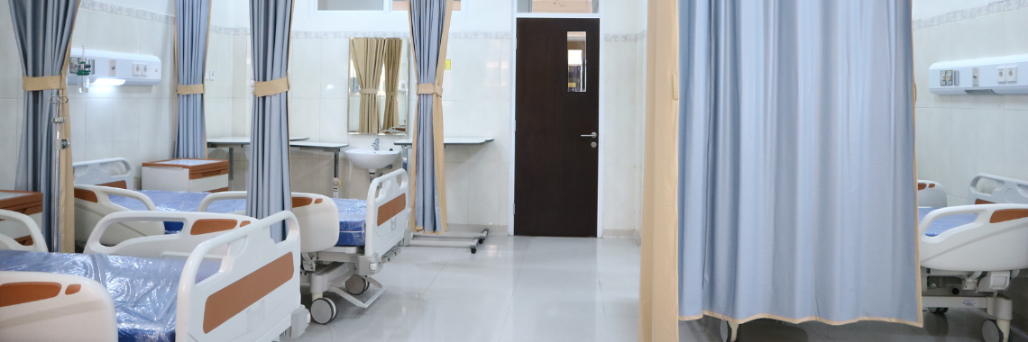 An empty hospital room with multiple beds