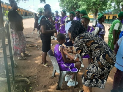 Doctor administering HPV vaccine to young boy
