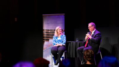 Dean Jodi Sandfort and Lt. Governor Denny Heck lead conversation from stage