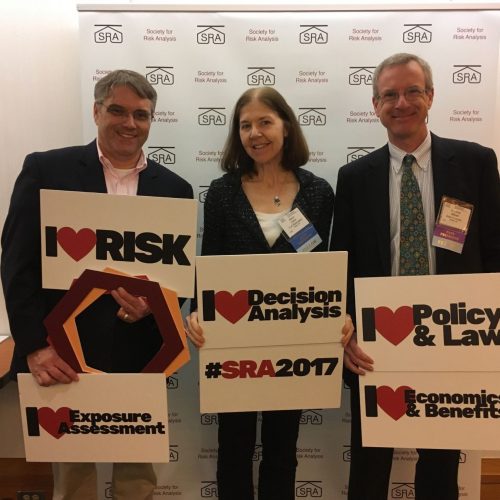 Alison Cullen at Society for Risk Analysis Alison Cullen stands between two other researchers, all holding signs celebrating the Society for Risk Analysis 2017 Conference