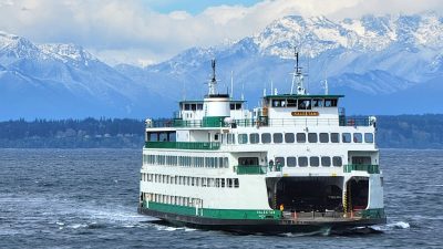 Ferry Washington State Ferry crosses puget sound with Olympic Mountains in the distance
