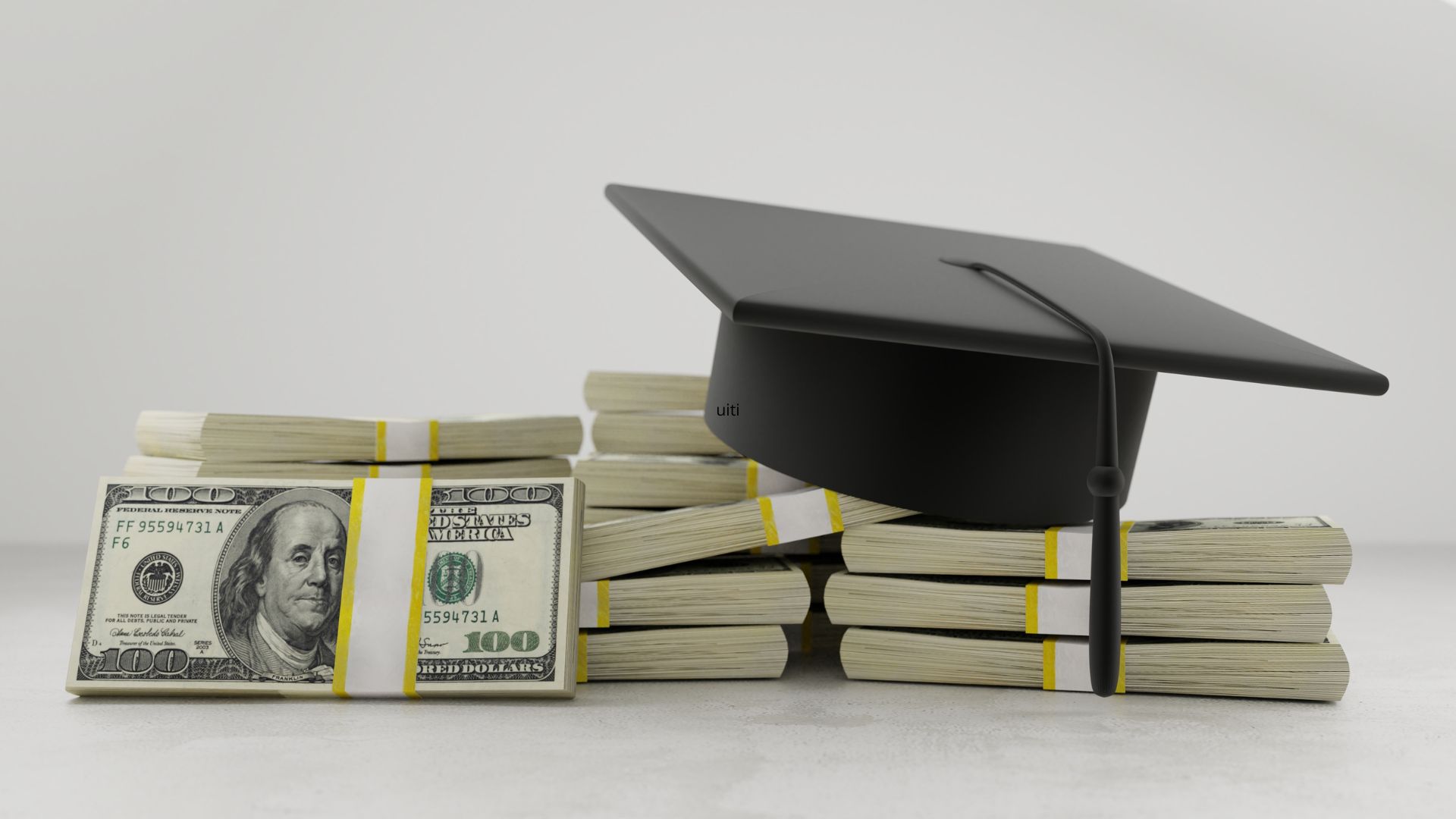 A graduation cap sits on a pile of American money
